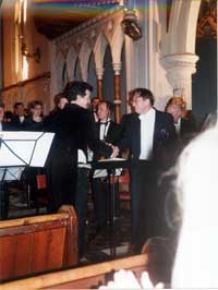 Photo of Stephen Bennett shaking hands with David Hoyland at the successful completion of the first performance of Hoyland's Rhapsody for Clarinet and orchestra